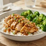 Slow Cooker Honey Garlic Chicken served over rice with glossy honey garlic sauce