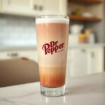 A glass filled with a mixture of Dr Pepper and milk, visually distinct as a finished drink.
