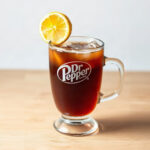 Finished Hot Dr Pepper drink in a clear glass mug, showcasing the warm beverage's color and steam.